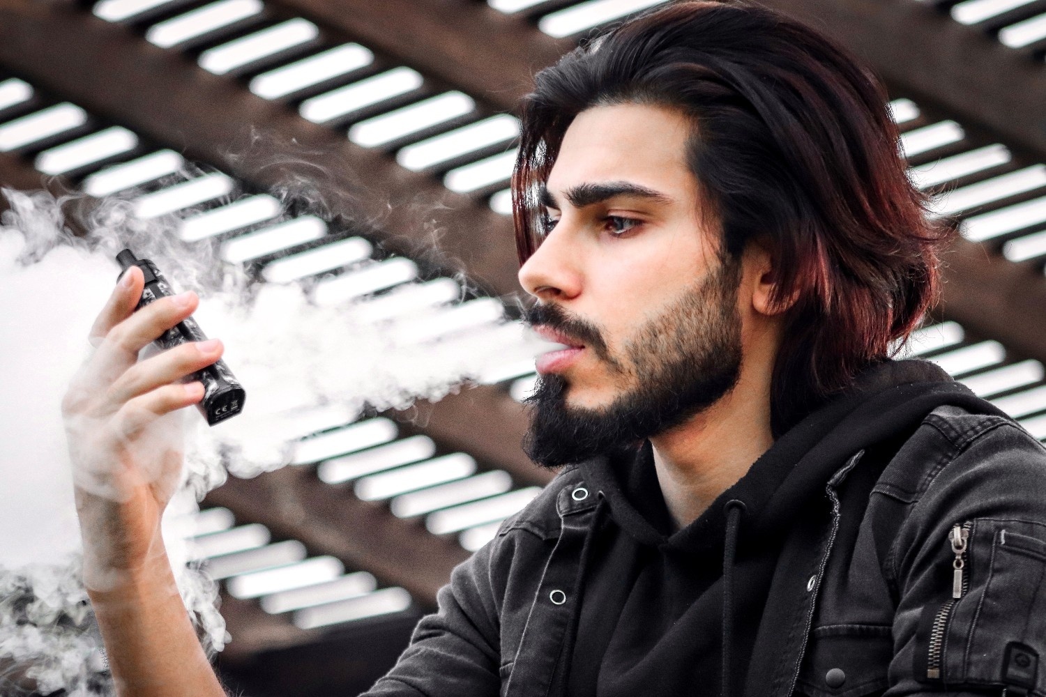 man-looking-at-vape-device.jpg